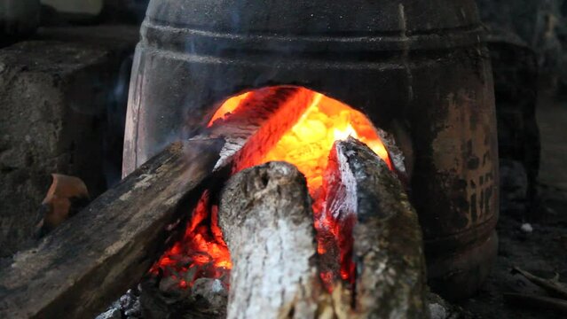 Anglo is a traditional stove or furnace made from clay on old Javanese kitchen set. Firewood as fuel. Fire is burning