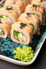 Assorted sushi nigiri and maki big set on slate. A variety of Japanese sushi with tuna, crab, salmon, eel and rolls. Top view