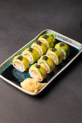 Assorted sushi nigiri and maki big set on slate. A variety of Japanese sushi with tuna, crab, salmon, eel and rolls. Top view