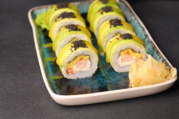 Assorted sushi nigiri and maki big set on slate. A variety of Japanese sushi with tuna, crab, salmon, eel and rolls. Top view