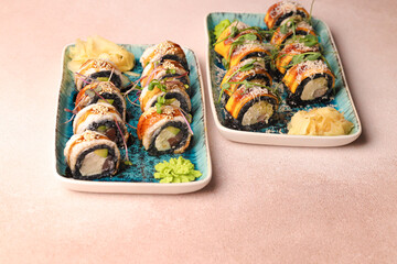 Assorted sushi nigiri and maki big set on slate. A variety of Japanese sushi with tuna, crab, salmon, eel and rolls. Top view