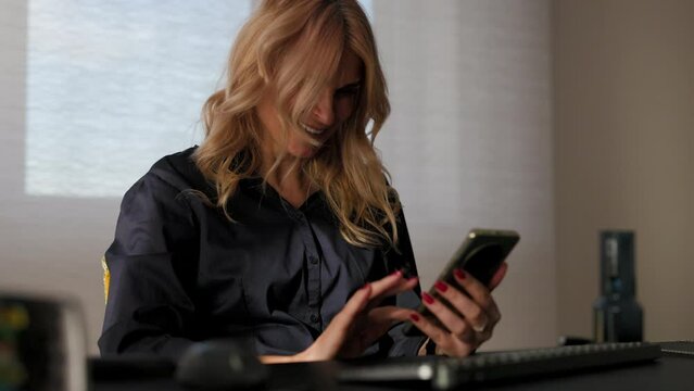 business woman sits in front of the computer at the office and talks on the phon