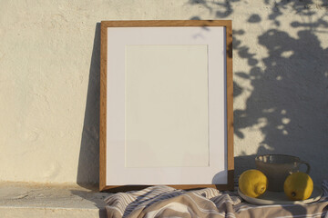 Neutral vertical wooden frame picture mockup against white old textured white wall in sunlight....