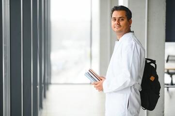 Portrait of a handsome Indian medical student. The concept of higher education.