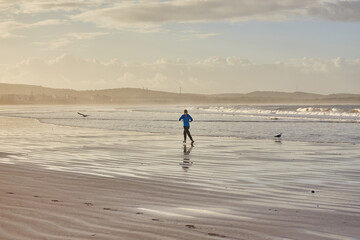 A young woman embraces the tranquility of a seaside run along Essaouira's ocean