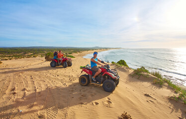 A group of tourists enjoys quad biking along Essaouira's oceanfront
