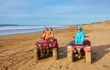 A group of tourists enjoys quad biking along Essaouira's oceanfront