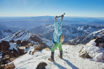 A triumphant tourist at the peak of Mount Toubkal, Morocco