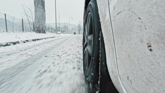Car Front Winter Tyre Close Up Driving Through Slushy Mud Snow Covered Icy Road