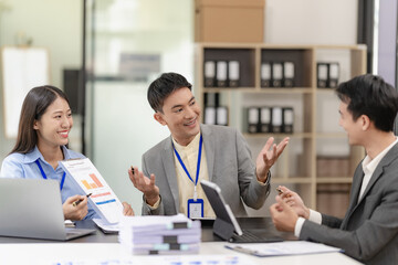 Team of successful Asian businessmen in suits working in conference room to discuss brainstorming, computation, analysis together on company growth goals and gross profit margins. - obrazy, fototapety, plakaty