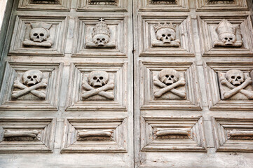 Detail of the old wooden door of the Church of Purgatory, Matera, Italy.