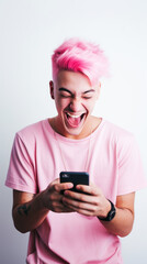 A pink-haired young man looking at the smartphone and laughing closeup.