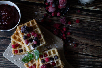 Hungarian waffles with berries on a wooden background. Breakfast. Dessert