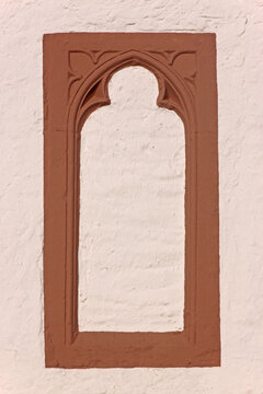 Pointed arch with gothic tracery on a blind window frame at the village church of Brecht, Eifel region in Germany