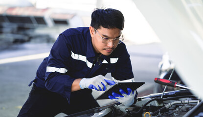 Service workers use tablets to inspect cars for maintenance. Smart car service work. Car business...