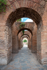 Close-up view of red brick Roman arches among the ruins of the famous Roman Forum (Foro Romano) in Rome, Italy