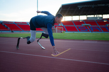 Disabled athletes prepare in starting position ready to run on stadium track