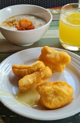 deep fried chinese dough, rice porridge and pineapple juice. Breakfast menu in Thailand.
