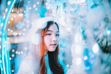 Portrait of young woman with blue background bokeh