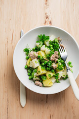 Potato salad with tuna and green peas.