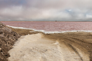 The pink water of a salt flat near Walvis Bay, Namibia, a major exporter of raw salt.