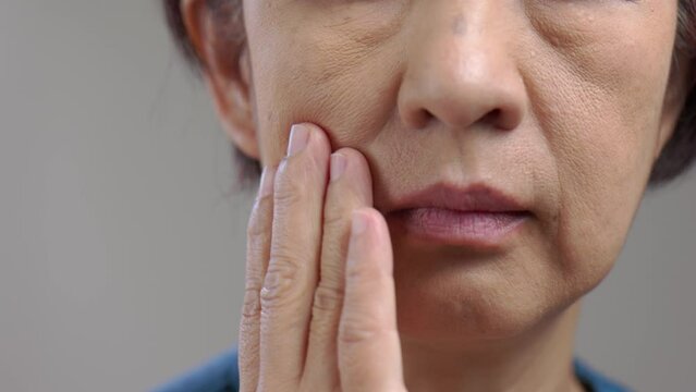 Flabby and wrinkled skin on senior woman face.