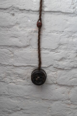 Old black rosette on a white stone wall. Repairs