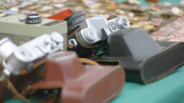 vintage photography equipment at a street sale. Old Cameras lying on the counter