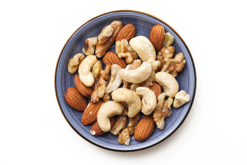 Peeled walnuts isolated on white. Tapas nuts serving. Blue plate with nuts. Pile of cashew nuts. Healthy snack portion. Closeup macro almonds structure.