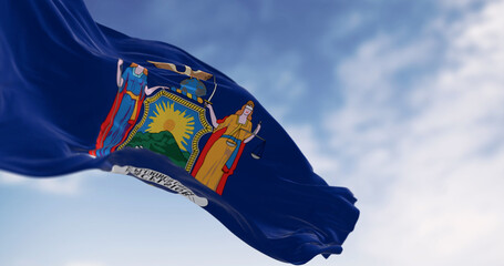 Close-up of New York State flag waving on a clear day