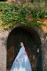 Tourist girl wearing traditional korean hanbok at the Gyeongbokgung Palace in Seoul, South Korea.