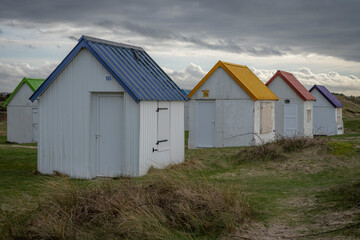 Gouville, France - 12 30 2023: View of colorful bathing wooden cabins of Gouville on the dunes.