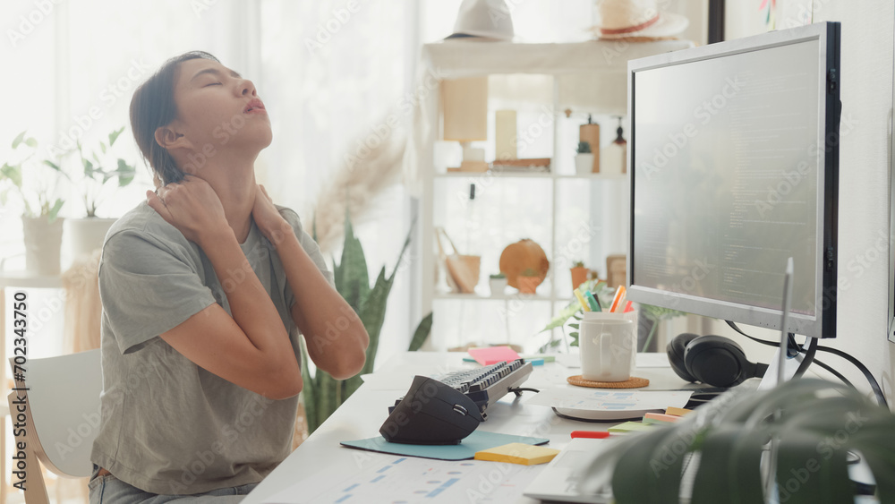 Wall mural young asia girl development programmer overwork tired painful shoulder neck muscle from office syndr