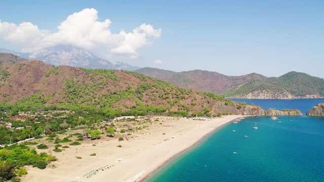 Drone shooting on the beach and down to the sea. Beaches and people swimming in the sea in summer. &Ccedil;ıralı, Antalya coast in the summer of 2023. 4K coast and beach shots.