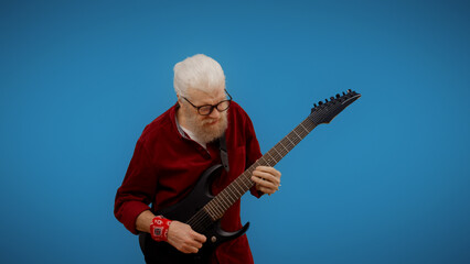 Mature man plays the guitar, indulging in rock and roll for entertainment and embracing being...