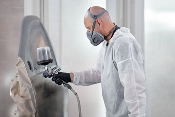 The respirator-wearing artist ensures a safe work environment while skill fully breathing life into...