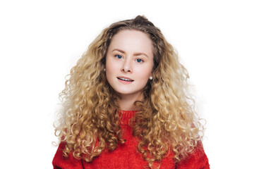 Vivacious young woman with curly blonde hair in a warm red sweater, radiating joy and comfort