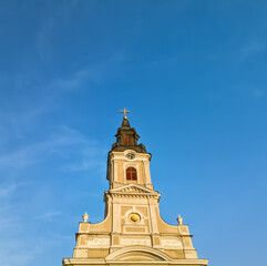 Fototapeta na wymiar Christian church tower on a clear blue sky with copy space, minimalist composition 