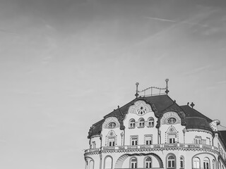 Art nouveau building facade with a clear sky background and copy space. Black eagle palace in Oradea old town, minimalist black and white edit