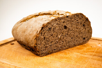 Close-up picture of a hand made and home made tradition french bread witha beautiful crust on a wooden cutting board