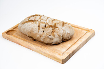 Close-up picture of a hand made and home made tradition french bread witha beautiful crust on a wooden cutting board