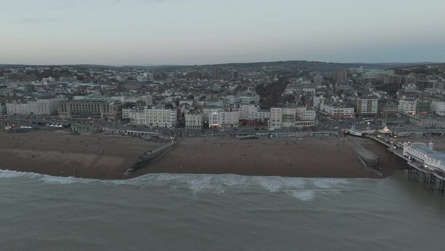 Pier and fair ground in Brighton by the beach aerial drone with waves and sea D Log M