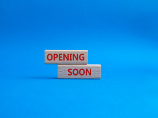 Opening soon symbol. Concept word Opening soon on wooden blocks. Beautiful blue background. Business and Opening soon concept. Copy space