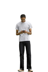 A man in a gray T-shirt, on a white background, full-length, with a phone