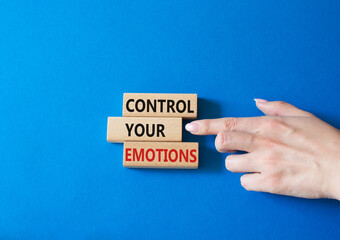 Control Your Emotions symbol. Concept word Control Your Emotions on wooden blocks. Doctor hand. Beautiful blue background. Psychology concept. Copy space