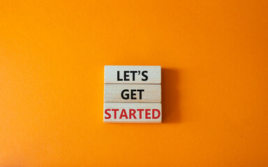 Lets get started symbol. Concept words Lets get started on wooden blocks. Beautiful orange...