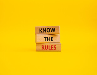 Know the rules symbol. Wooden blocks with words Know the rules. Beautiful yellow background....