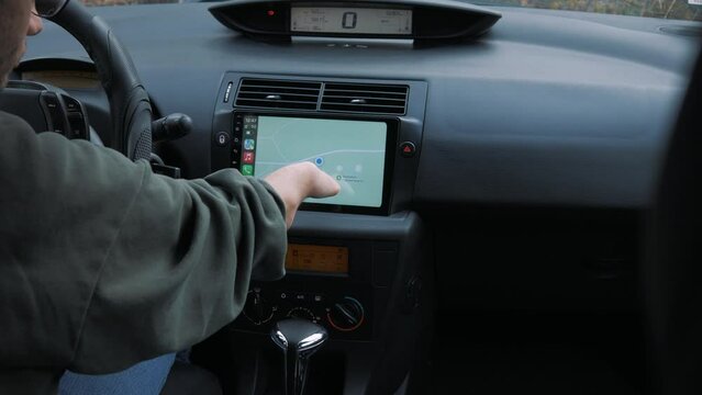 A disabled person uses navigation in a car. Preparation of the route. A disabled person is driving