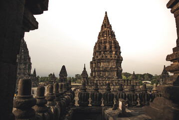 historic Prambanan Temple ruins of Yogyakarta, Central Java, Indonesia during a cloud sunset time .
