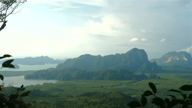 Scenic panorama of tranquil lake surrounded by lush forest and majestic mountains. Nature and travel destination.